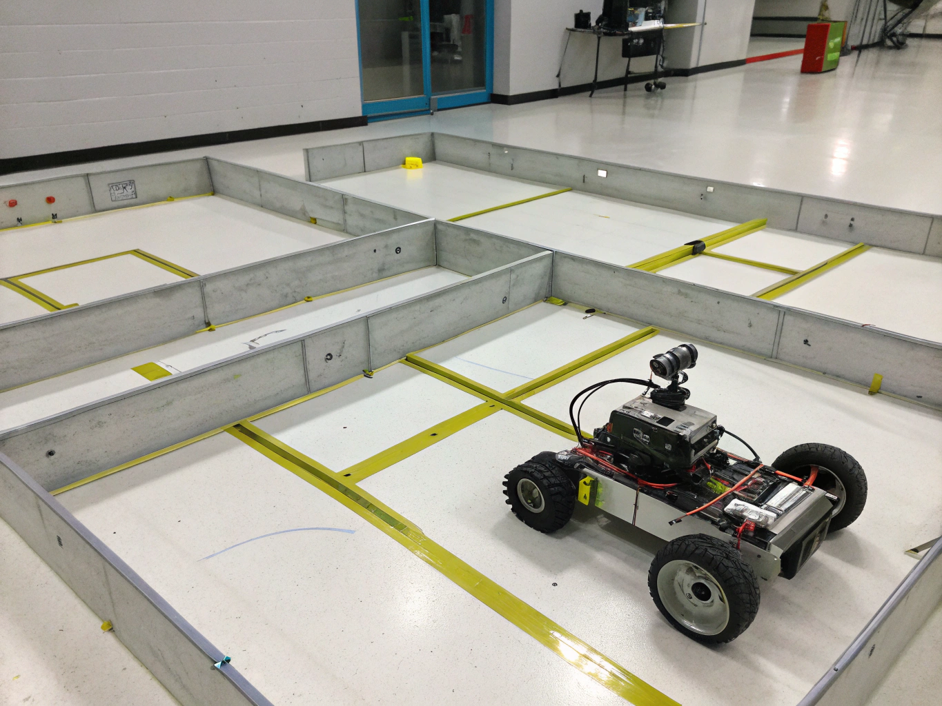 Wheeled robot with touch and infrared sensors approaching an obstacle